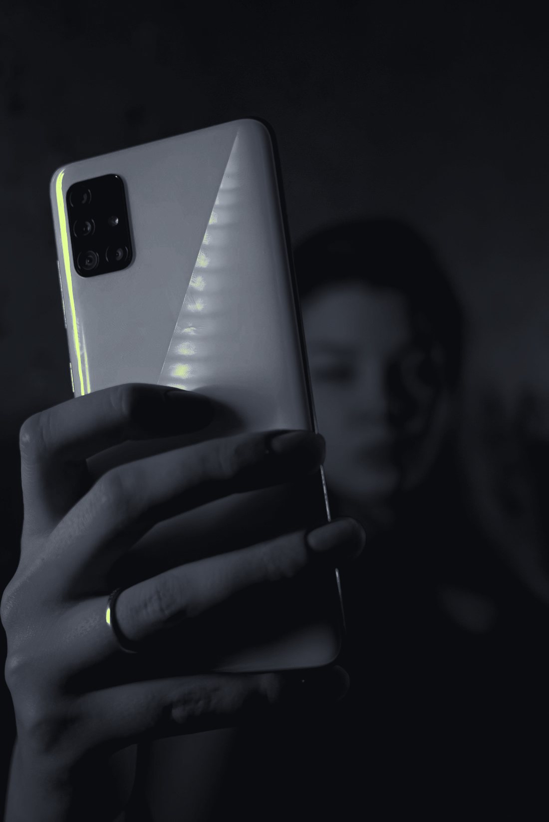 Smartphone with an app store in hand under neon light
